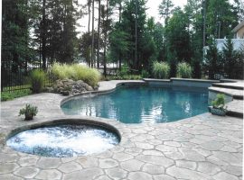 freeform swimming pool and hot tub with concrete surround