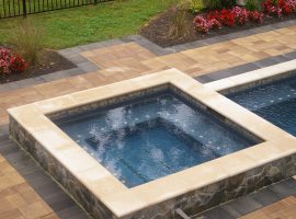 square swimming spa outdoors with tanning shelf