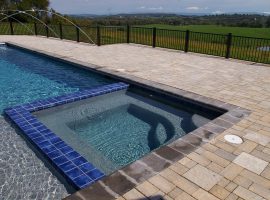 rectangular swimming pools and spa with water fountains